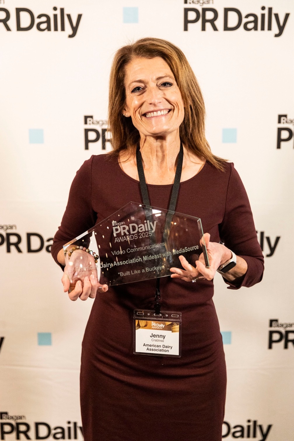 Jenny Crabtree holds Best In Video Communications Award for ADA Mideast and MediaSource